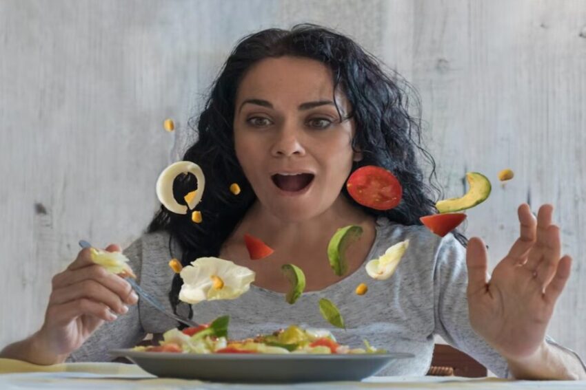 Person enjoying a healthy meal practicing mindful eating and savoring the pleasure of food (Vitamin P).